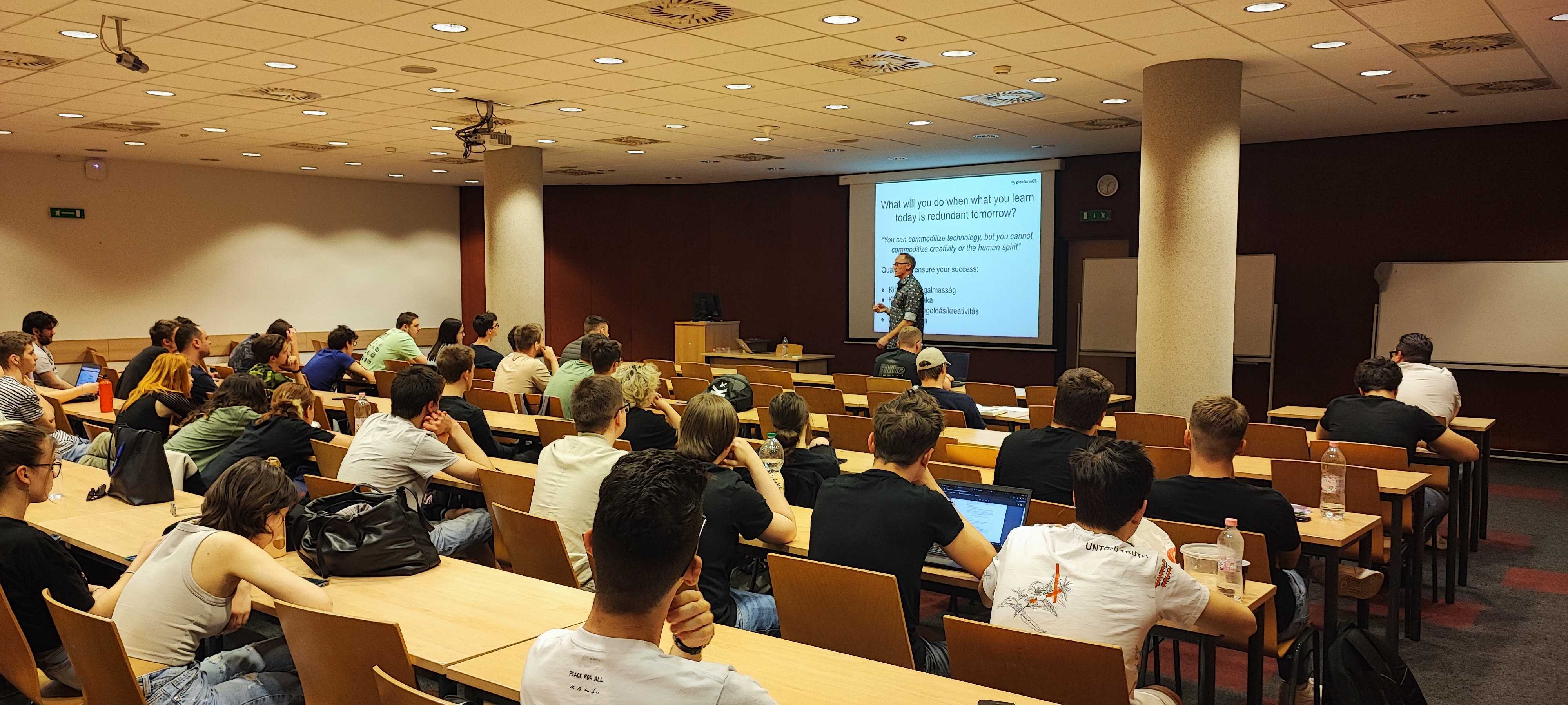 Adam Boadway holding a presentation in front of many students of the University of Szeged